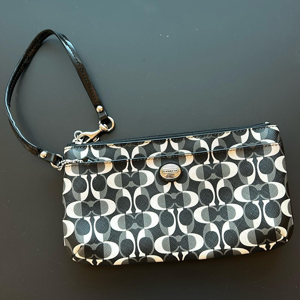 Coach wristlet with lots of space. Card holders and additional zipper pocket.